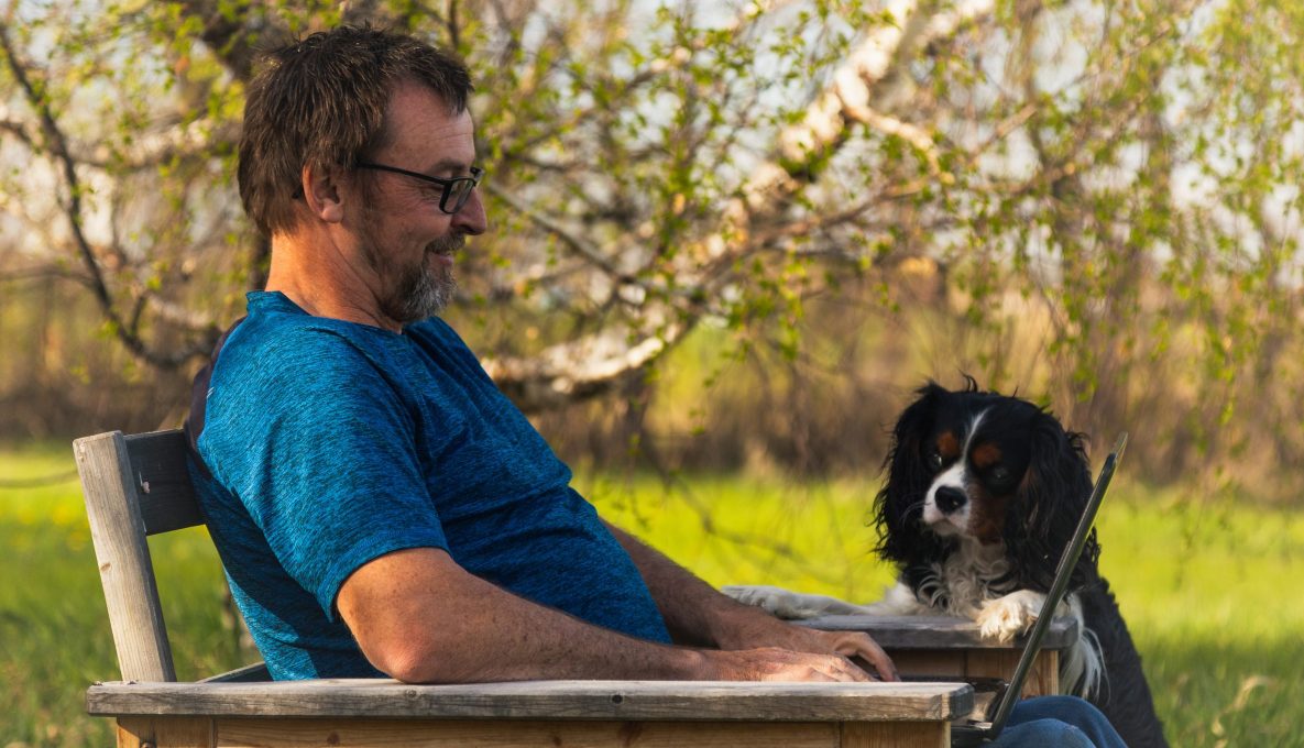 Man on his laptop with dog