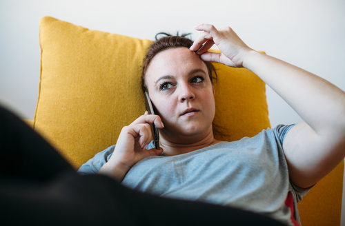 Woman on couch talking on phone