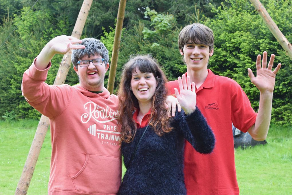 Autistic adults smiling and waving