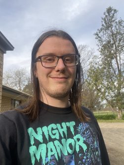 Man with glasses smiling outdoors
