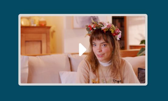 A young woman with a flower crown on video still